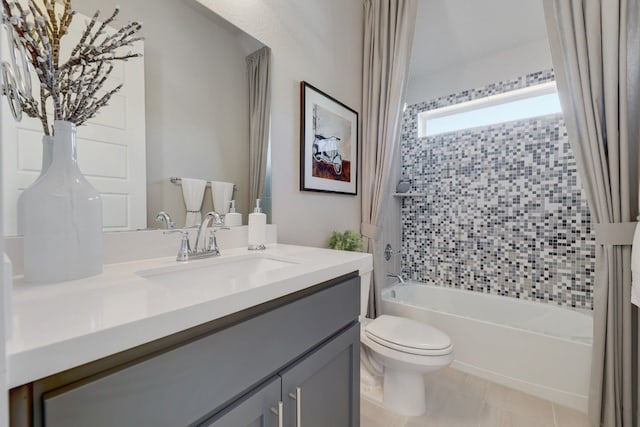 full bathroom featuring tile patterned flooring, shower / bath combo with shower curtain, vanity, and toilet