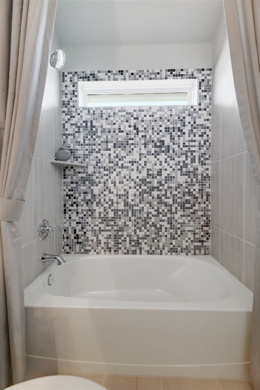 bathroom with toilet and shower / tub combo with curtain