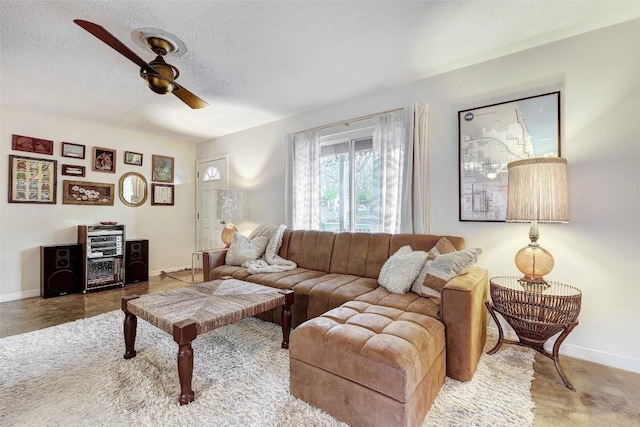 living room with a textured ceiling and ceiling fan