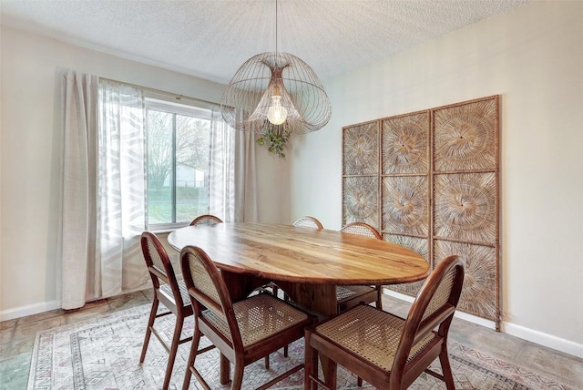 dining space with a textured ceiling