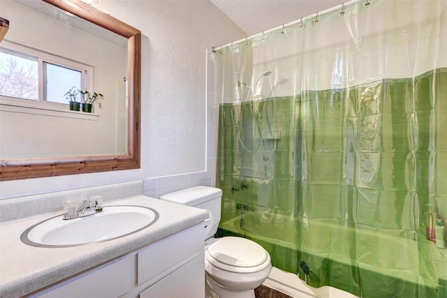 full bathroom with vanity, shower / bathtub combination with curtain, and toilet