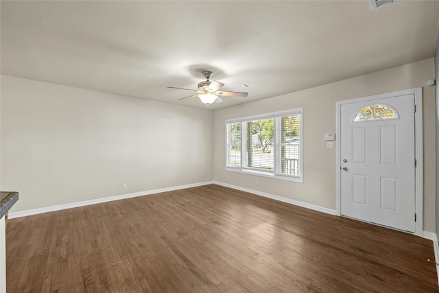 entryway with ceiling fan and dark wood-type flooring