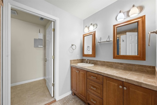 bathroom with tile patterned floors and vanity