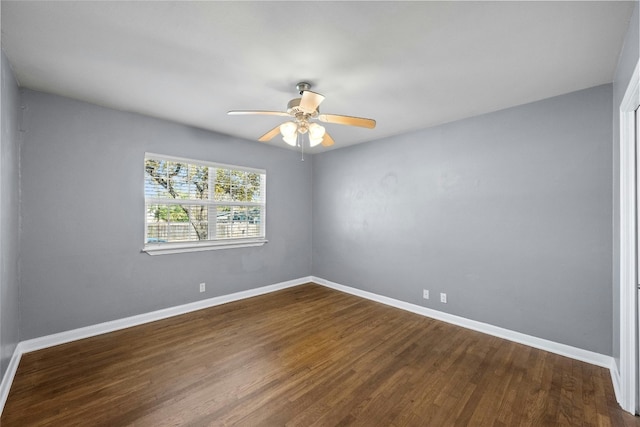 spare room with dark hardwood / wood-style floors and ceiling fan