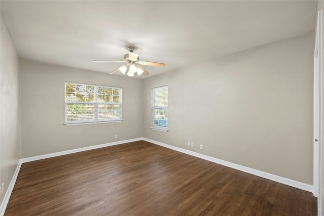 unfurnished room with dark hardwood / wood-style floors and ceiling fan