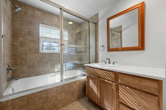 bathroom featuring tile patterned flooring, vanity, and combined bath / shower with glass door