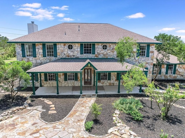 colonial inspired home featuring a patio area