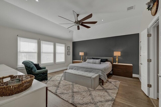 bedroom with wood-type flooring, vaulted ceiling, and ceiling fan