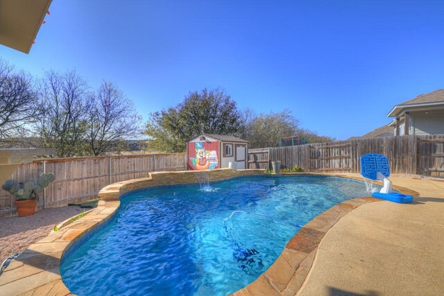 view of pool featuring pool water feature and a storage shed