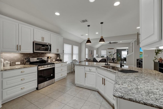 kitchen featuring white cabinetry, sink, lofted ceiling, a kitchen island with sink, and appliances with stainless steel finishes