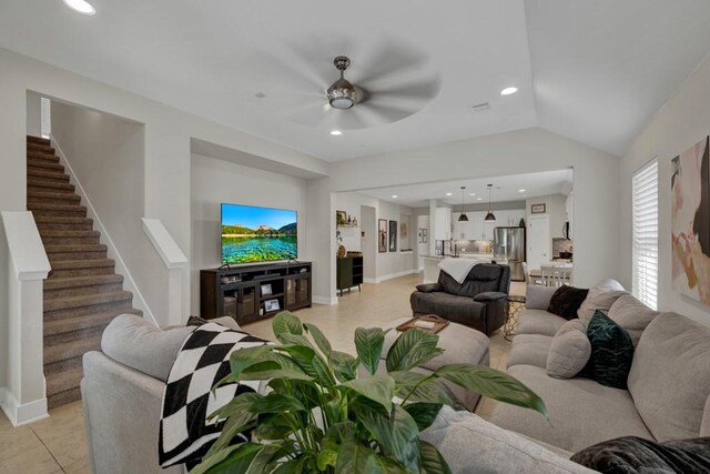 tiled living room featuring ceiling fan and vaulted ceiling