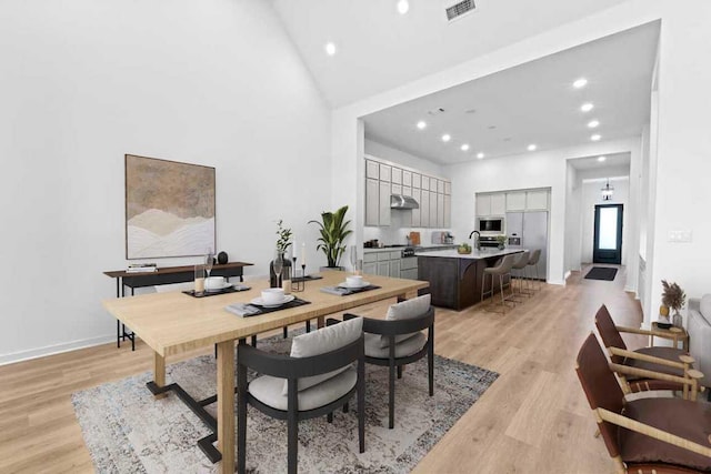 2120 Tobiano Trce, Georgetown, TX 78633 - dining area featuring recessed lighting, light wood-style flooring, high vaulted ceiling, and baseboards