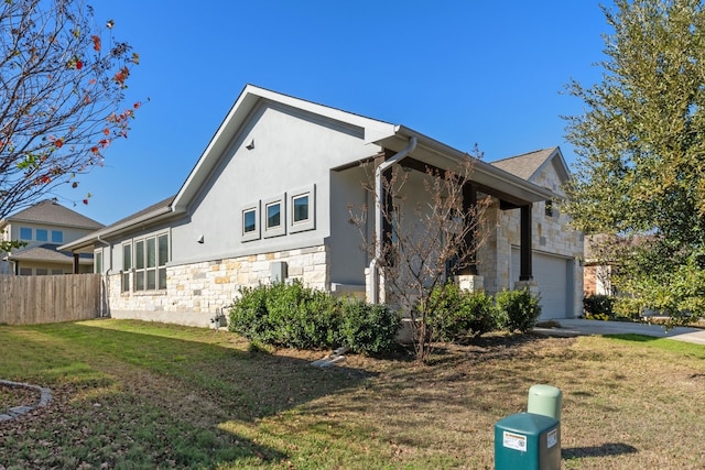 view of property exterior featuring a yard and a garage