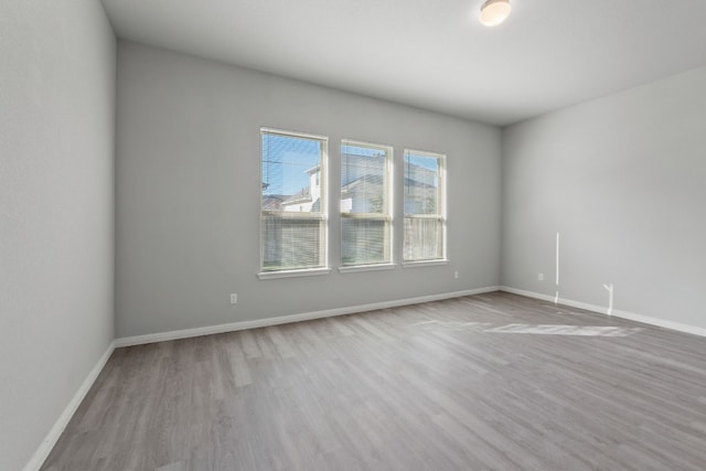 spare room with light hardwood / wood-style flooring