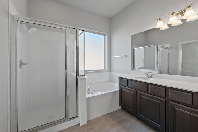 bathroom with vanity and independent shower and bath