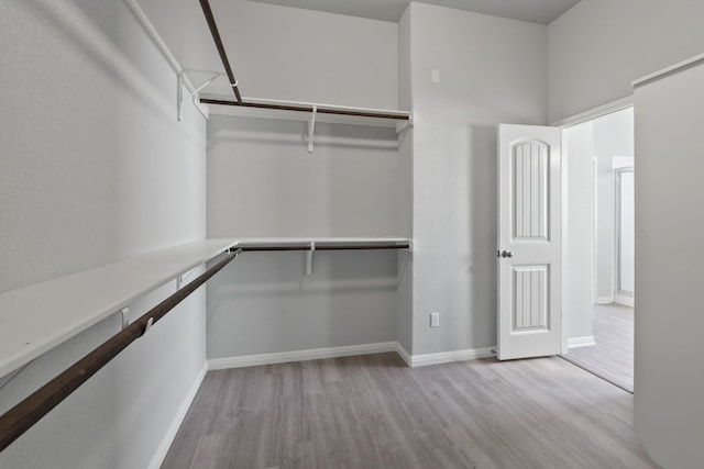 spacious closet with light hardwood / wood-style floors