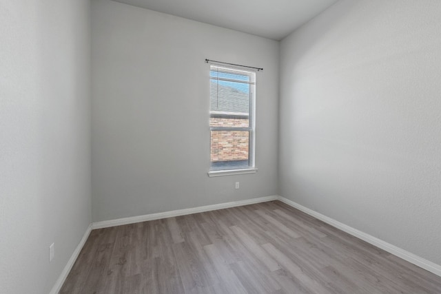 unfurnished room with light wood-type flooring