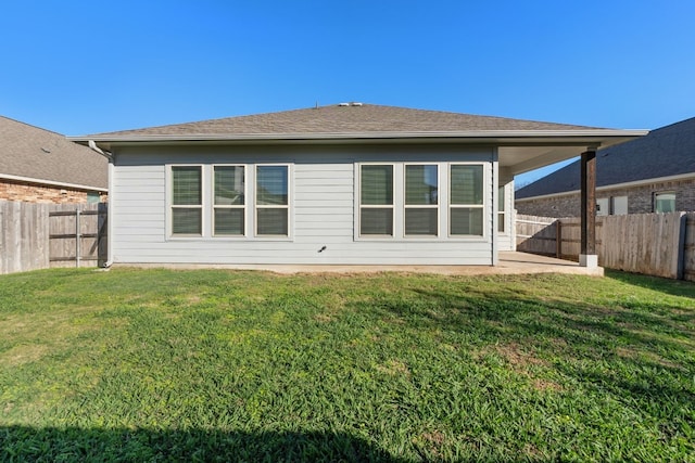 back of house featuring a yard and a patio