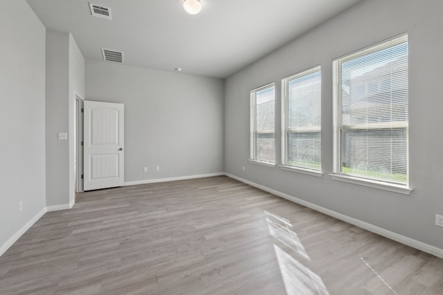 spare room with light hardwood / wood-style flooring