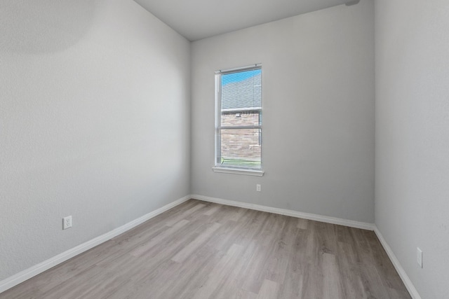 unfurnished room with light wood-type flooring