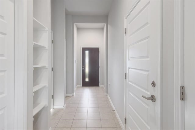 hall with light tile patterned floors