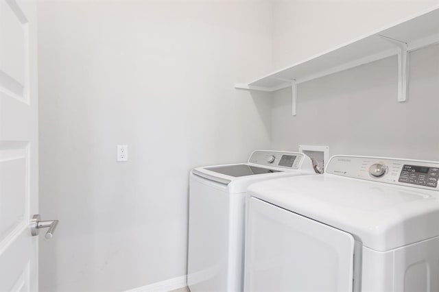 clothes washing area with separate washer and dryer