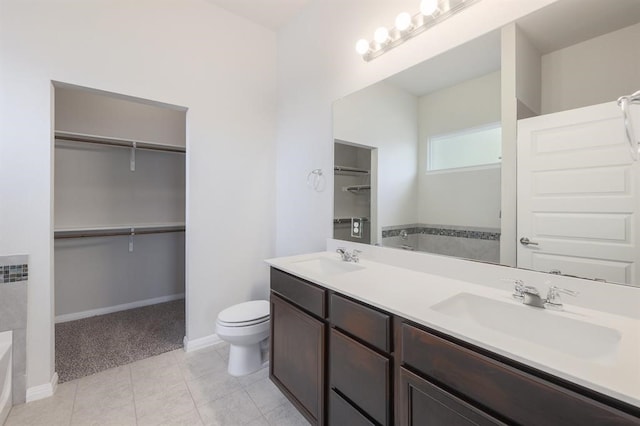 bathroom featuring tile patterned flooring, vanity, and toilet