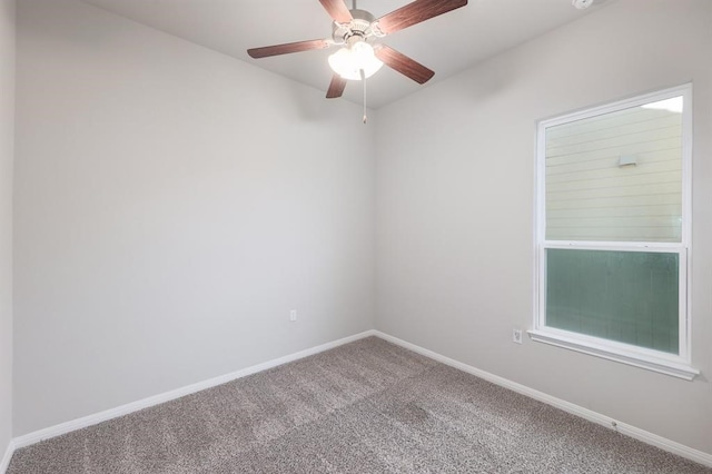 empty room featuring carpet flooring and ceiling fan