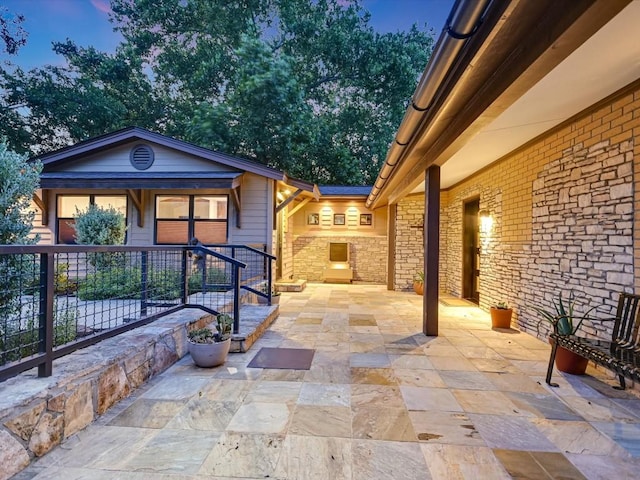 view of patio terrace at dusk