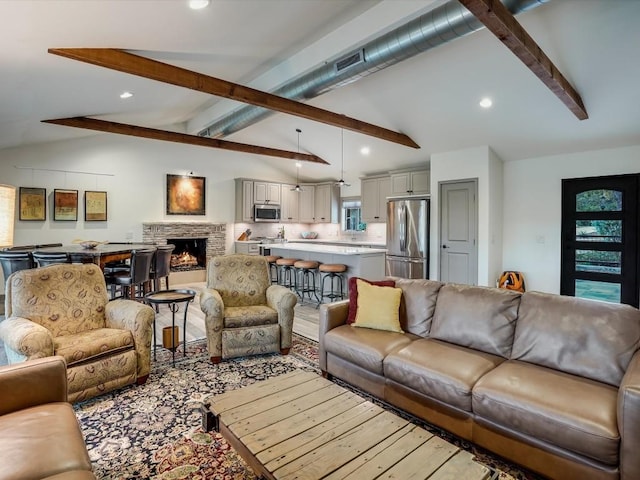 living room featuring a fireplace and vaulted ceiling with beams