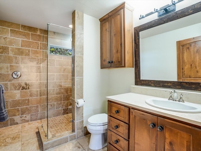 bathroom with toilet, vanity, and walk in shower