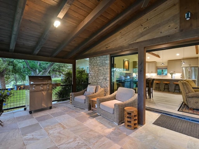 view of patio featuring a grill and exterior bar