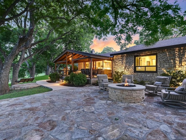 patio terrace at dusk with an outdoor fire pit