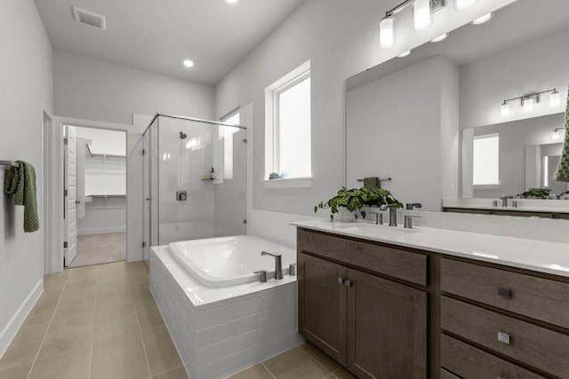 6304 Rotunda Vw, Austin, TX 78747 - full bath featuring a stall shower, a garden tub, vanity, tile patterned floors, and a spacious closet