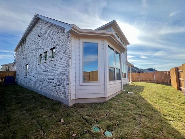 view of side of property with a lawn