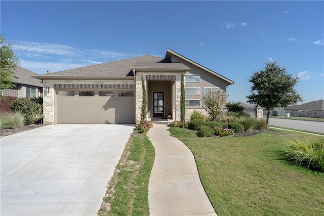 view of front of property with a front yard and a garage