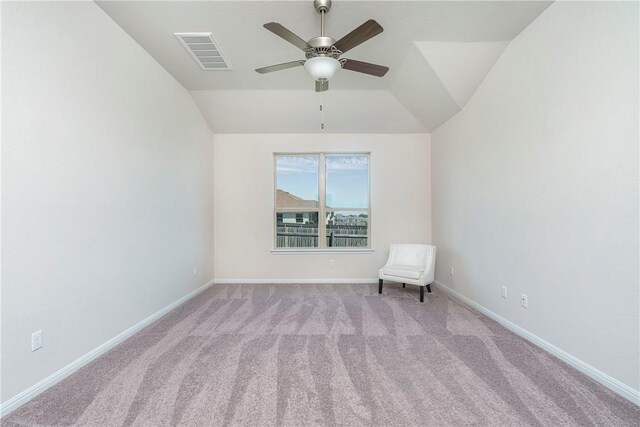 unfurnished room featuring light colored carpet, vaulted ceiling, and ceiling fan