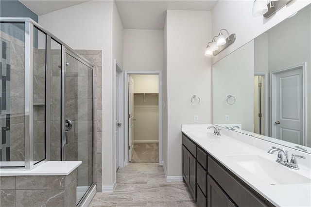 bathroom featuring vanity and an enclosed shower