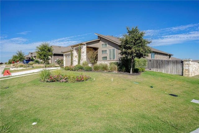 view of front of house featuring a front lawn and a garage