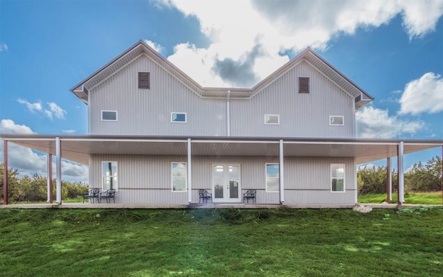 back of property featuring a lawn and french doors