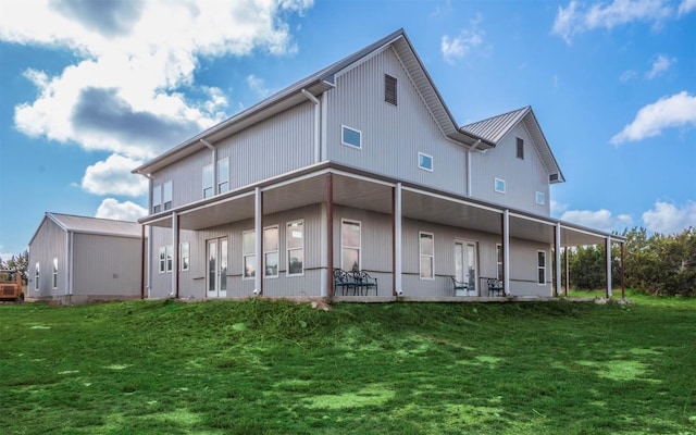 rear view of property with a yard