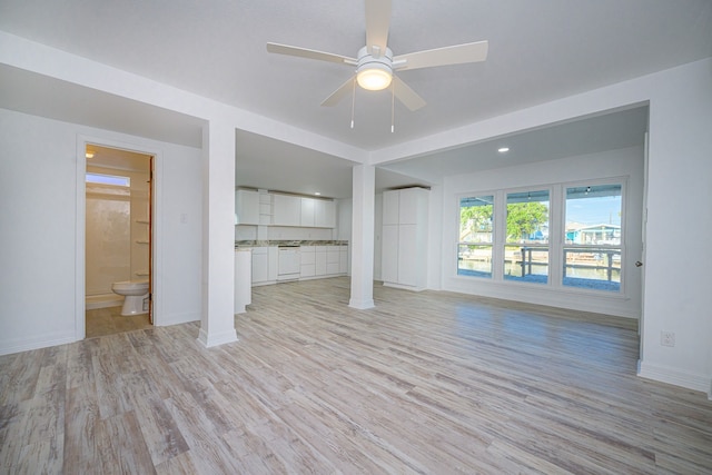 246 Starboard Ave, Rockport, TX 78382 - unfurnished living room featuring light wood-type flooring, ceiling fan, and baseboards
