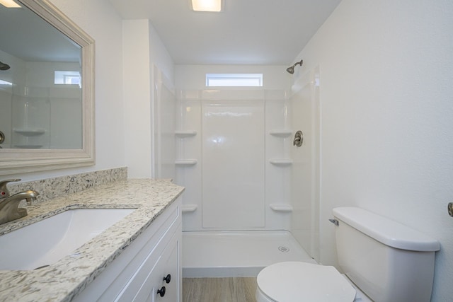 246 Starboard Ave, Rockport, TX 78382 - full bath featuring toilet, healthy amount of natural light, a shower, and wood finished floors