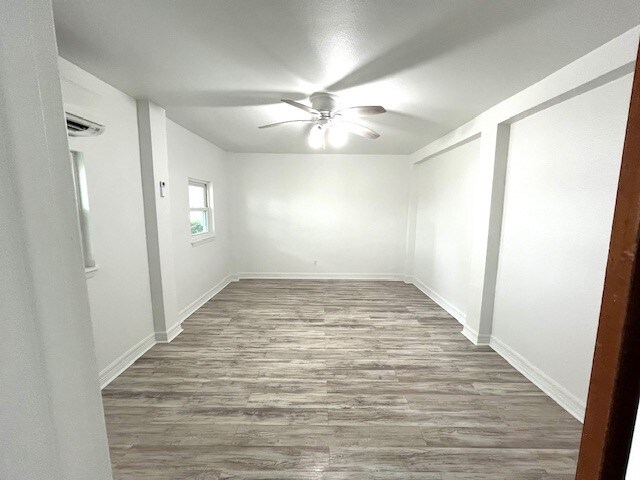 246 Starboard Ave, Rockport, TX 78382 - spare room featuring a ceiling fan, wood finished floors, and baseboards