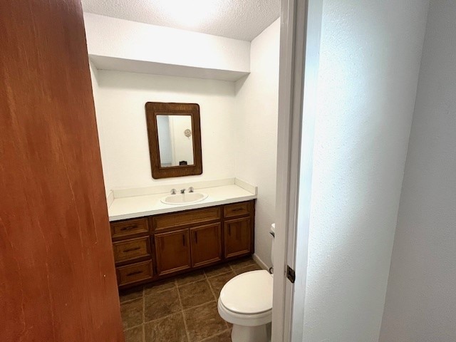 246 Starboard Ave, Rockport, TX 78382 - bathroom with vanity, toilet, a textured ceiling, and tile patterned flooring