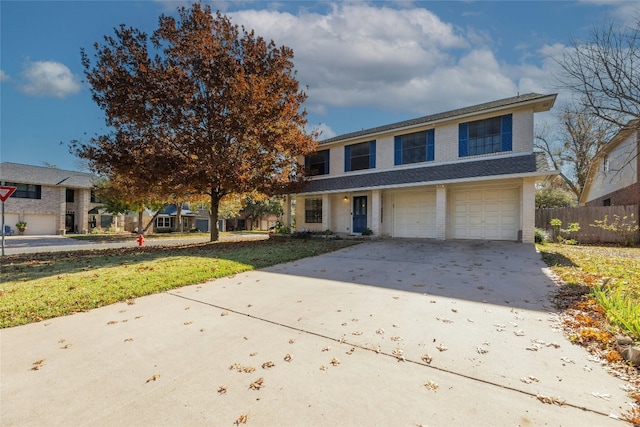 view of front of house with a front yard and a garage