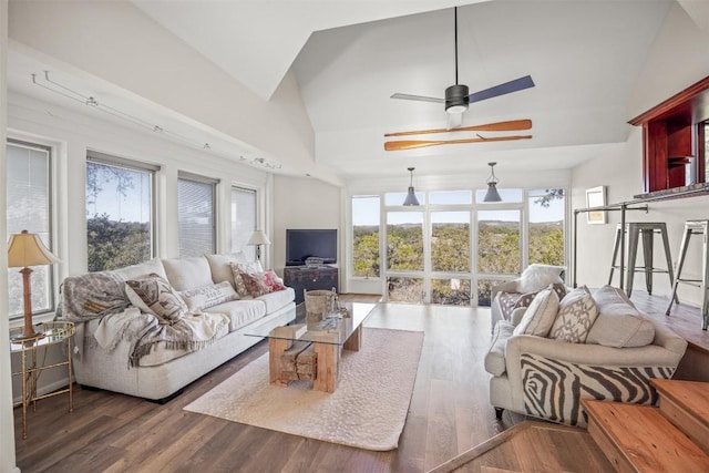 living room featuring ceiling fan, dark wood-type flooring, and vaulted ceiling