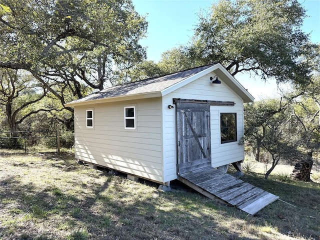 view of outdoor structure featuring a lawn