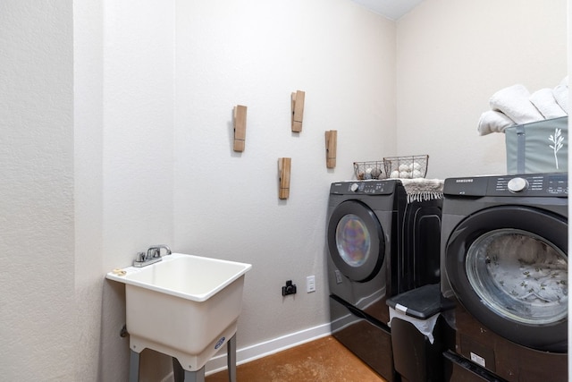 laundry room with washer and clothes dryer and sink