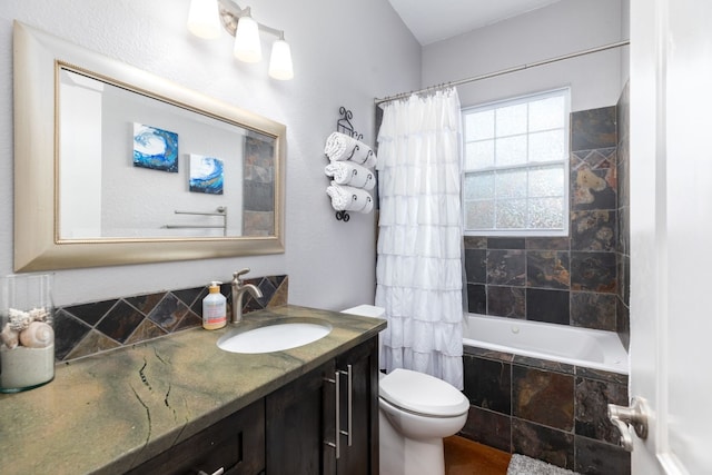 full bathroom with vanity, shower / bath combo, and toilet